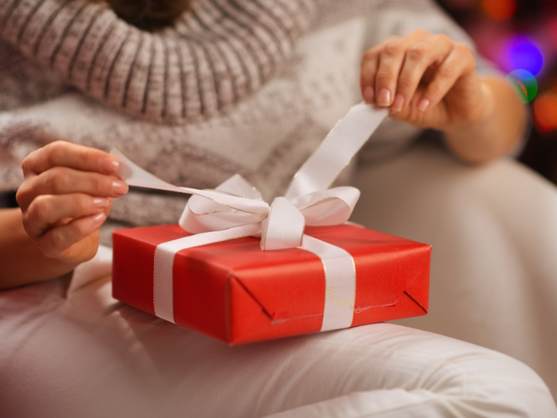 Woman opening Christmas present